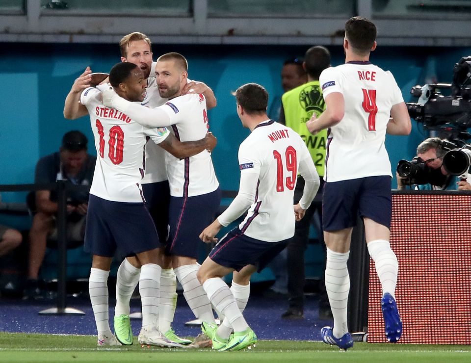 Kane is mobbed by his England team-mates