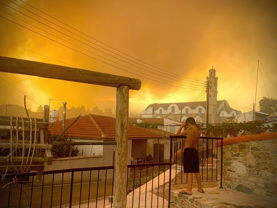 Smoke billows over the town of in Ora