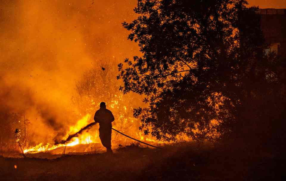 Firefighters desperately battled to beat back in the blaze as it swept Cyprus