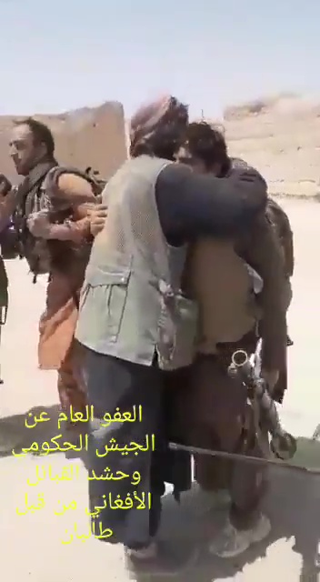 Taliban fighters hug surrendering Afghan soldiers