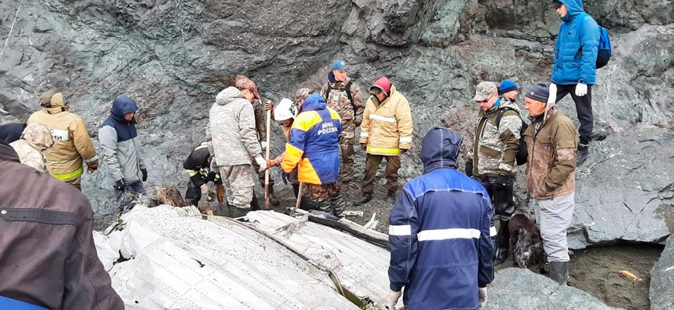 Debris is scattered at the foot of the coastal cliff face after the plane crashed in poor weather while taking a second approach to Palana airport