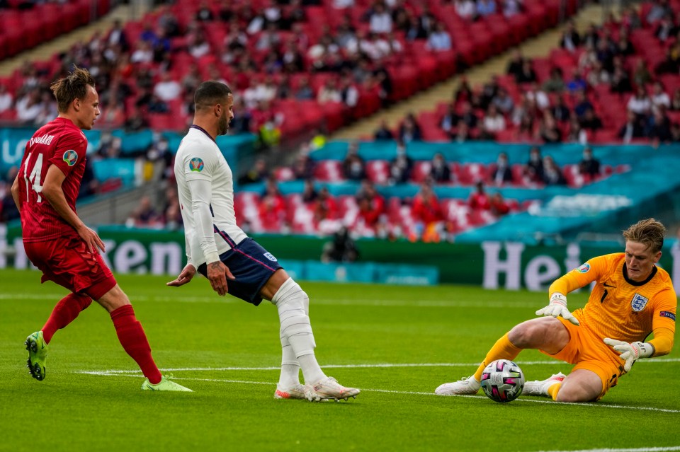 England's goalkeeper Jordan Pickford saves the ball next to Kyle Walker and Denmark's Mikkel Damsgaard