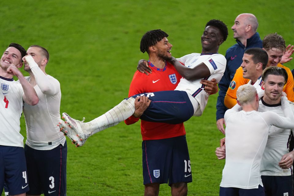 Mings picked up Saka after the game amid jubilant scenes on the Wembley pitch