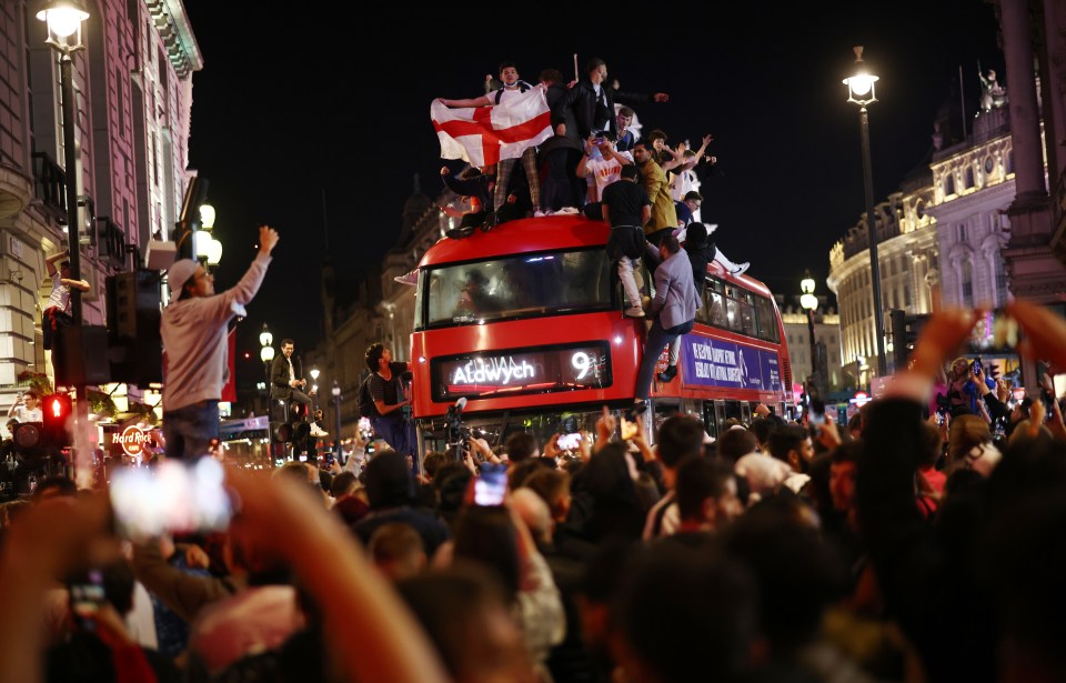 England fans celebrated by climbing atop a double decker bus in central London