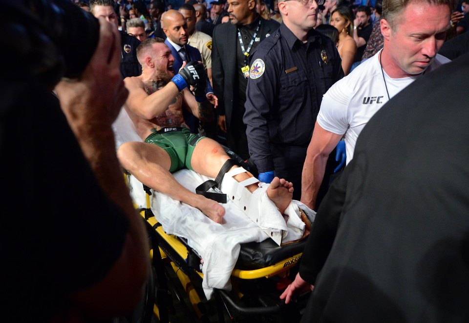 McGregor gets taken out of the Octagon on a stretcher after the ankle injury