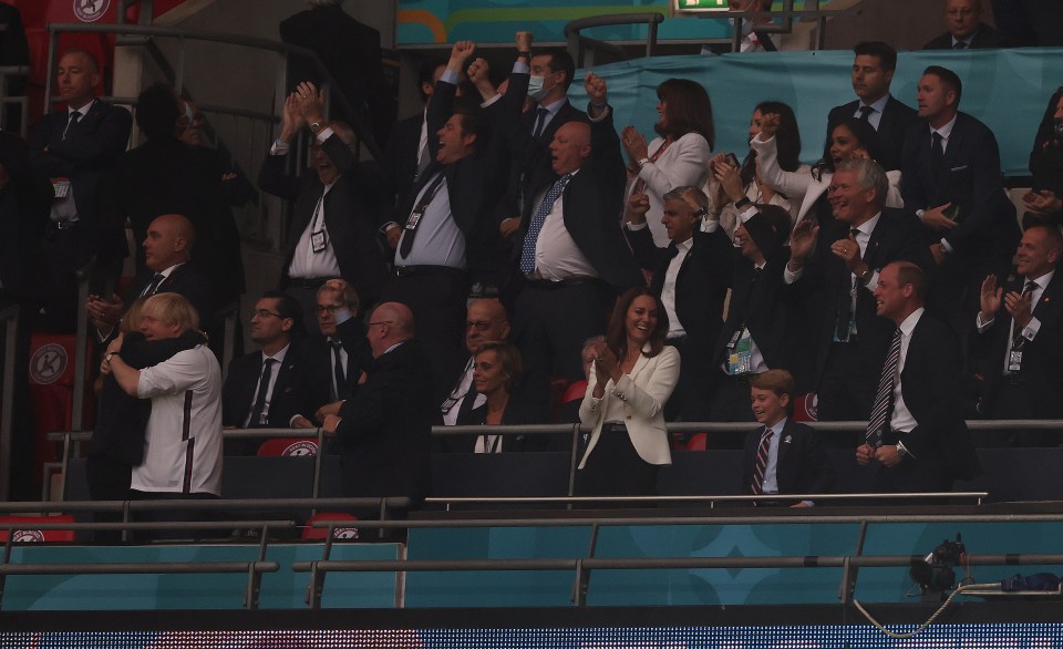 The PM (far left) hugs Carrie as Kate Middleton, Prince George and Prince William celebrate the goal