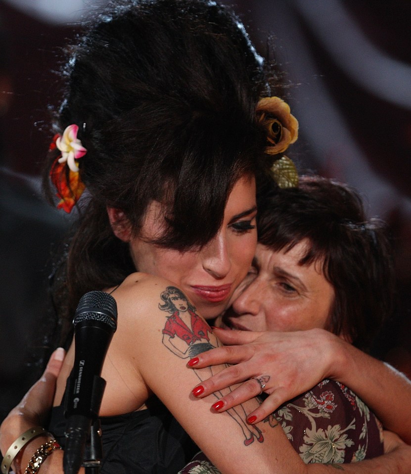 Amy hugs her mum Janis after accepting a Grammy Award in 2008