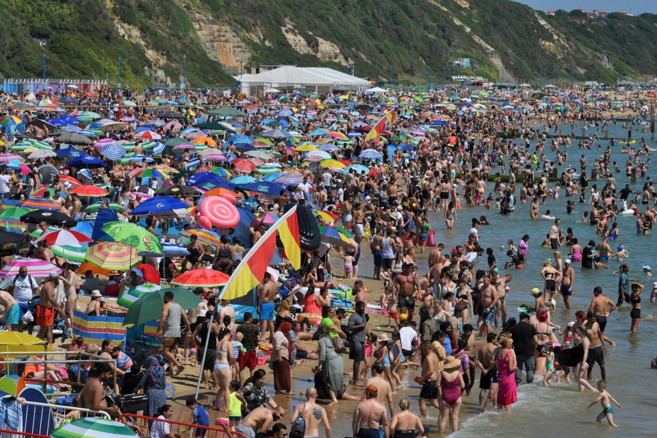 Beachgoers at Bournemouth Pier in Dorset