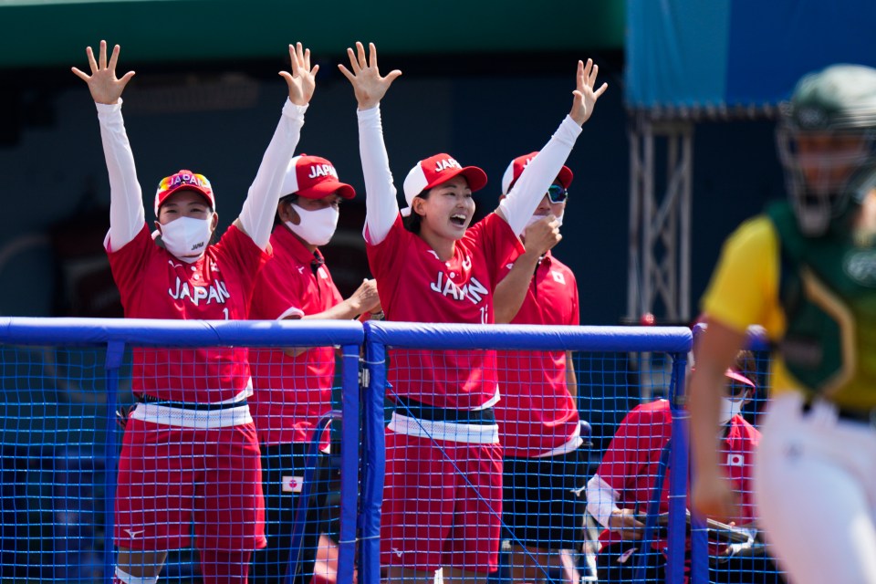 Japanese players celebrate after Minori Naito scores a run in the clash in Fukushima