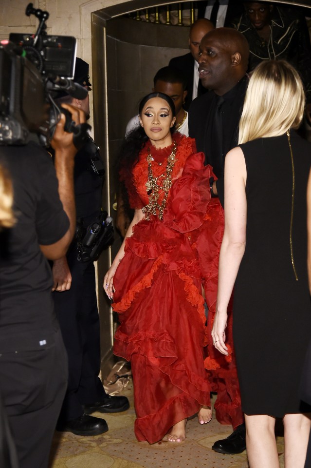 Cardi is escorted out, shoeless, after throwing her designer heels at Nicki Minaj