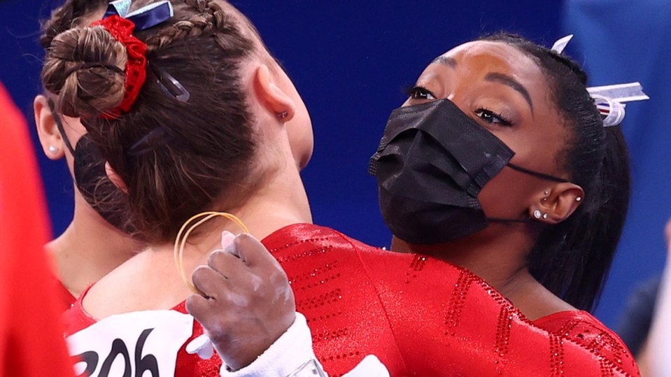 A USA team-mate comforts Biles after her Vault mistake