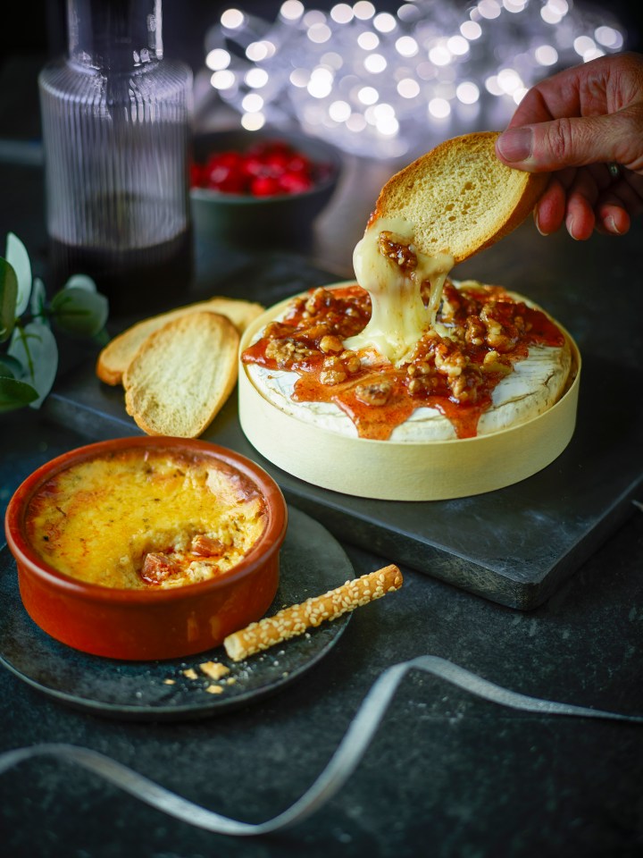 Brie garnished with festive fruits, walnuts and a brandy glaze.