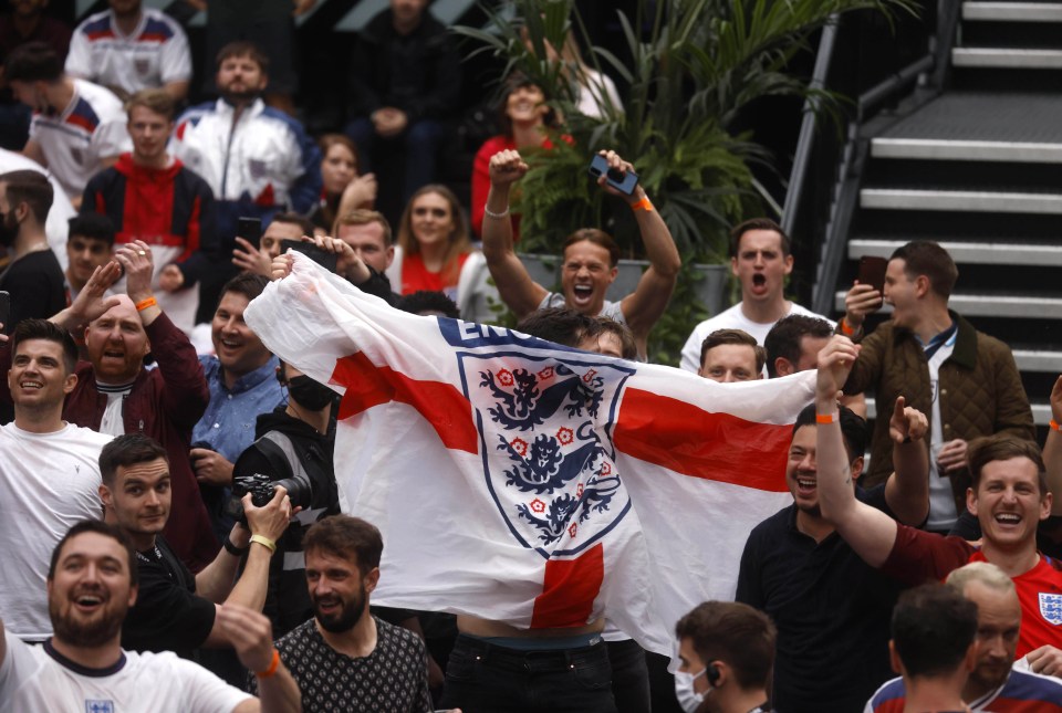 Fans celebrate England scoring against Germany at Boxpark in Croydon