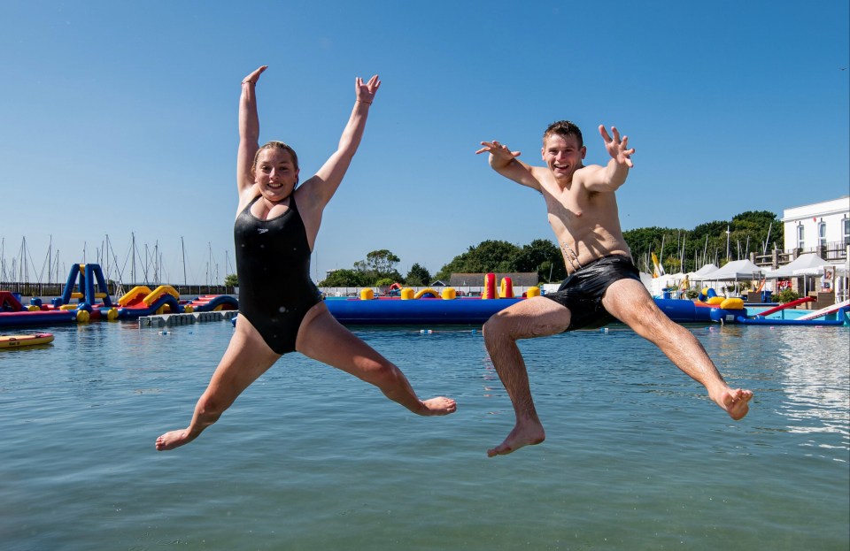 Lifeguards Georgia Squibb and Michael Guy cool off ahead of work in Lymington, Hants