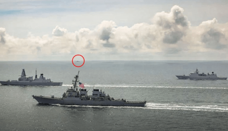 HMS Defender and HNLMS Evertsen and USS Laboon in operations in the Black Sea in June – with a Russian vessel visible on the horizon