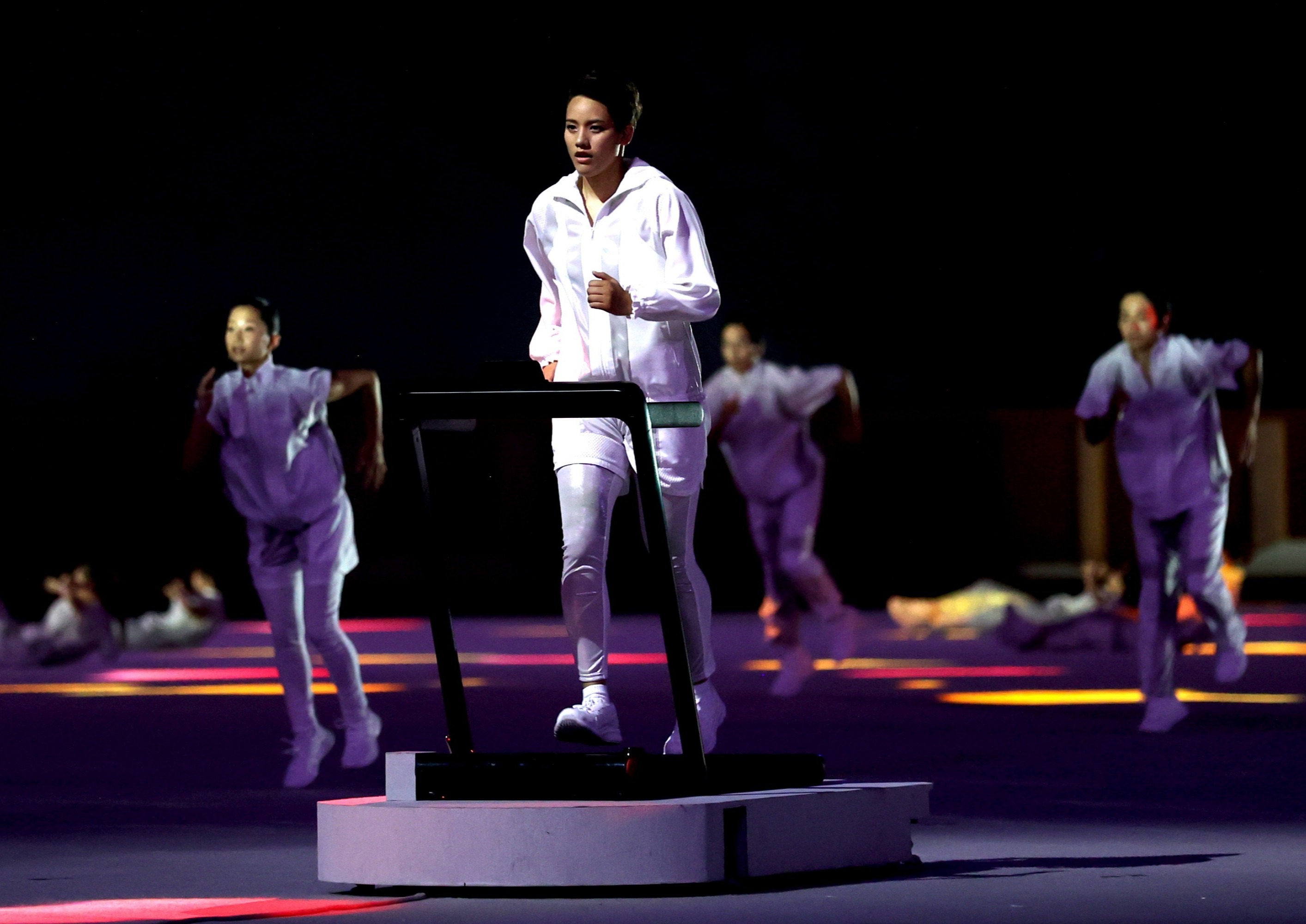 The focal point of the ceremony was a runner on a treadmill as Tokyo reflected on the coronavirus pandemic