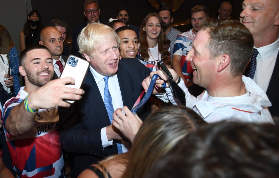 Boris Johnson posed alongside some athletes as he thanked the team for scooping 65 medals