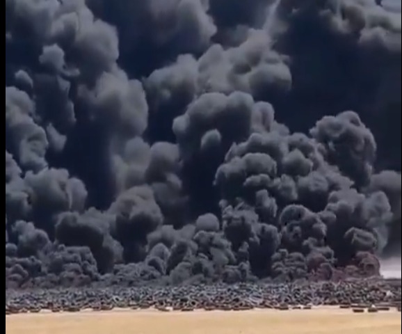 A thick wall of smoke coming from the burning tyres