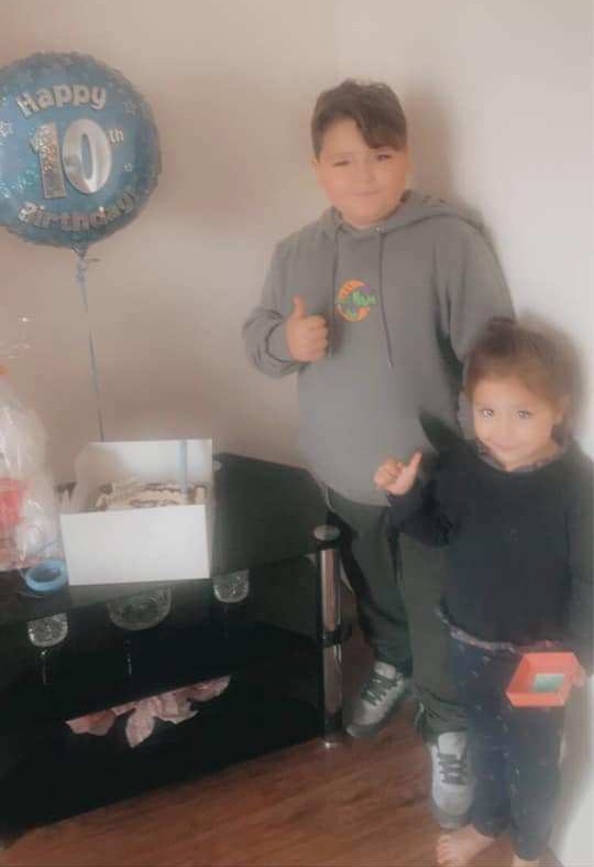 Smaller McCann, 10, standing next to his birthday cake and balloon hours before the fatal collision