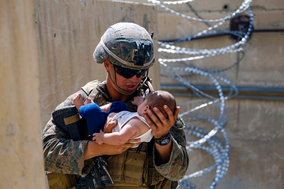 Some Afghans have been so desperate they're handing over babies to troops at Kabul airport