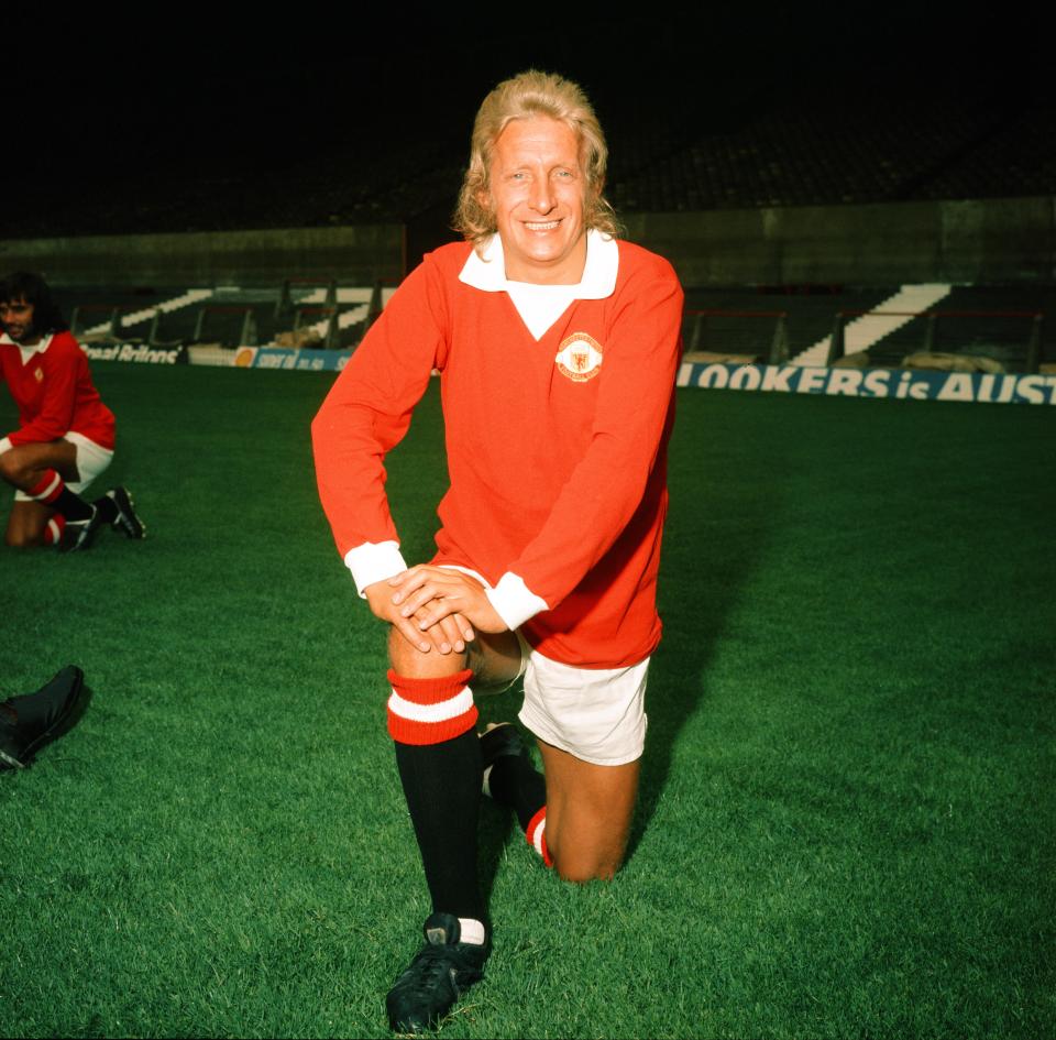 Denis Law of Manchester United kneeling on the field.