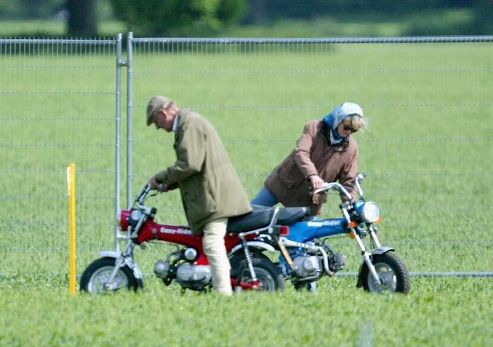 The pair mount their motorbikes during the Royal Windsor Horse Show at Home Park, Windsor Castle on May 13, 2005