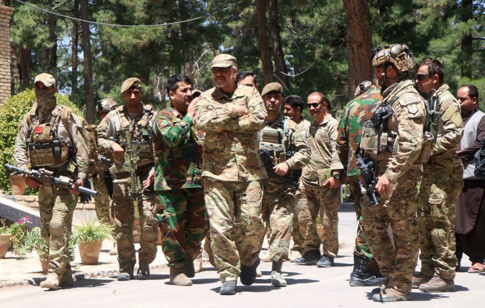 Afghan security officials arrive as part of a reinforcement to fight against Taliban militants as they push to gain access to the city in Herat