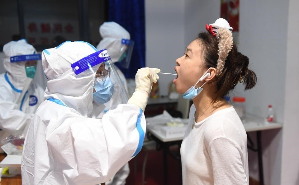 Medical workers take swab samples from citizens for Covid-19 in Zhengzhou City, central China's Henan Province