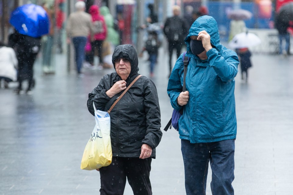 Shoppers brave the wind and rain in Liverpool city centre this afternoon