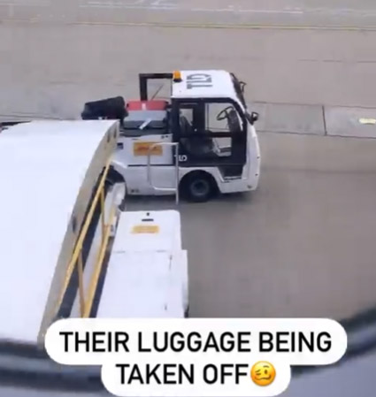 A shot of the men's luggage being removed from the plane