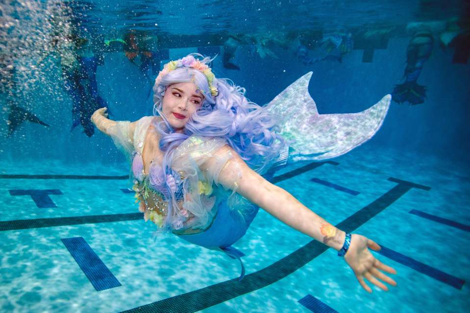 A mermaid swims during MerMagic Con at the Freedom Aquatic Center in Manassas, Virginia