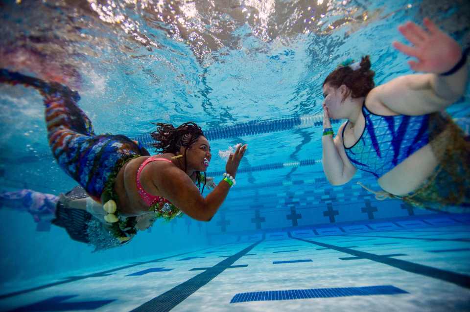 Members of the Society of Fat Mermaids share underwater kisses