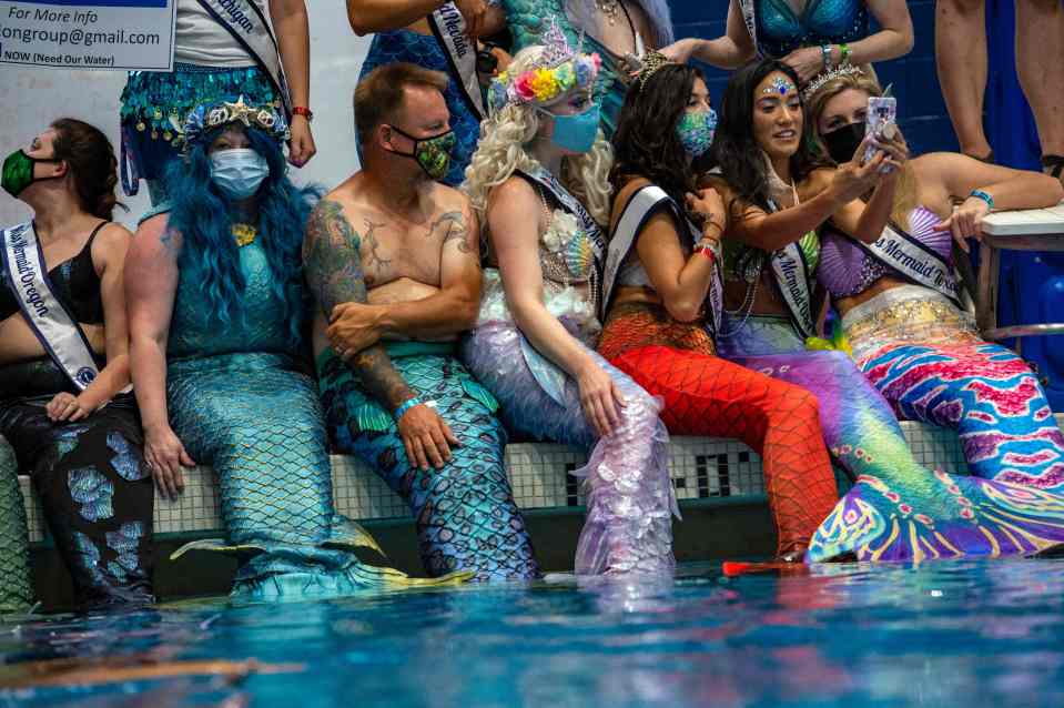 Mermaids and Mermen gather around the main pool