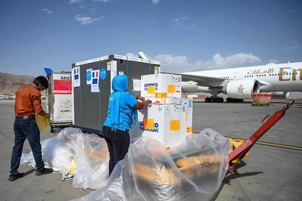 Unicef workers unload a shipment of Covid-19 vaccines after it arrived at Kabul airport