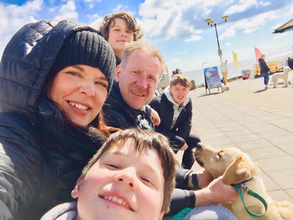 Lizzie is pictured above with her husband Paul, 47, and children Joshua, 16, Harry, 14, and Oscar, 11