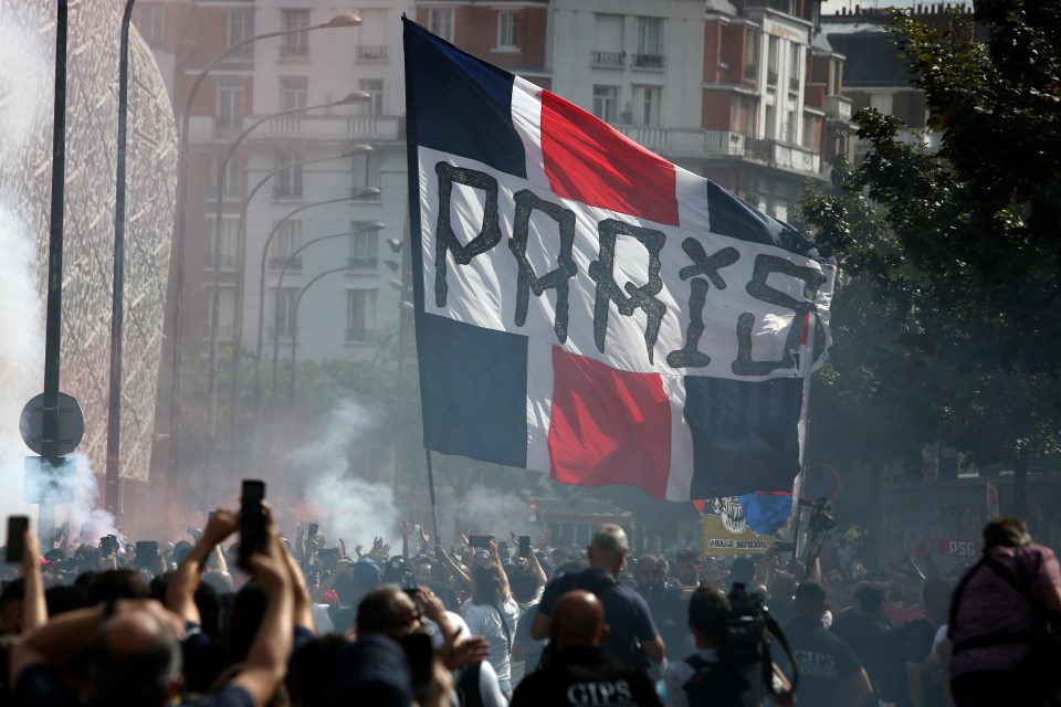 Fans waved flags and flares as they welcomed Lionel Messi to PSG