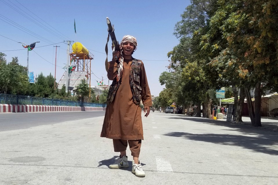 A Taliban fighter poses as he patrols inside the city of Ghazni, southwest of Kabul today