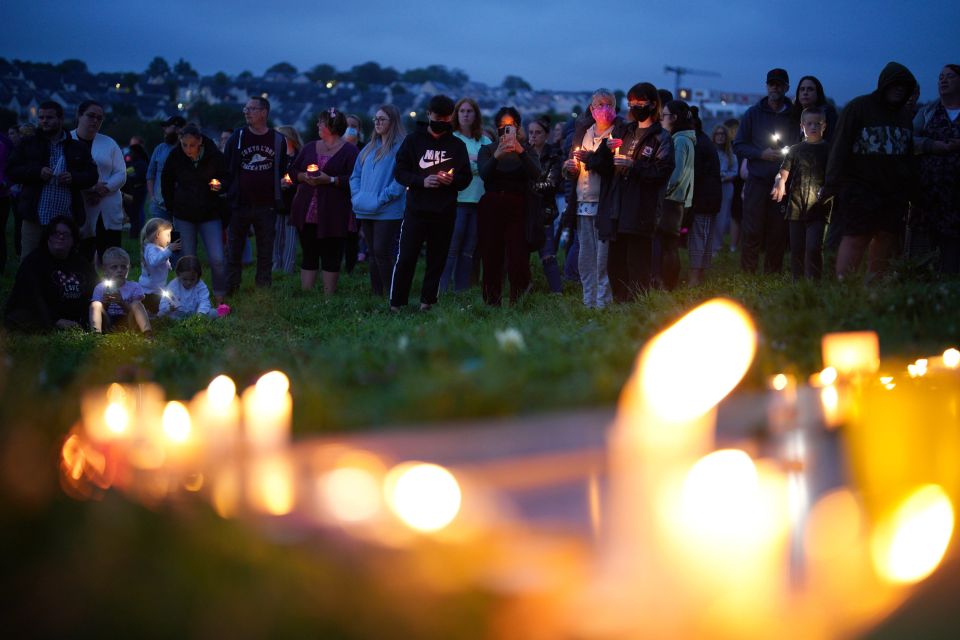 Members of the public attend a vigil for the victims of the mass shooting