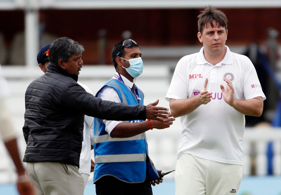 A fan casually invades the pitch during England's Test match with India