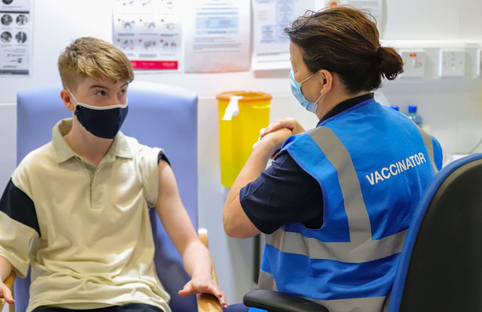 Kevin Mckeon, 14, receives his first dose of the Covid-19 vaccine