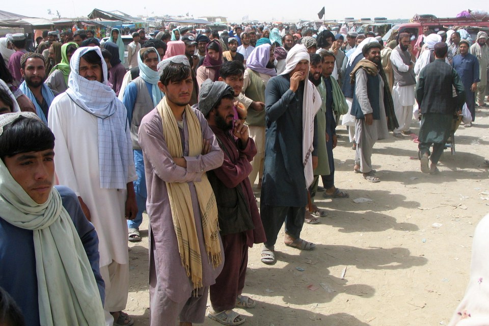 People wait to cross at the Friendship Gate crossing point at the Pakistan-Afghanistan border town of Chaman