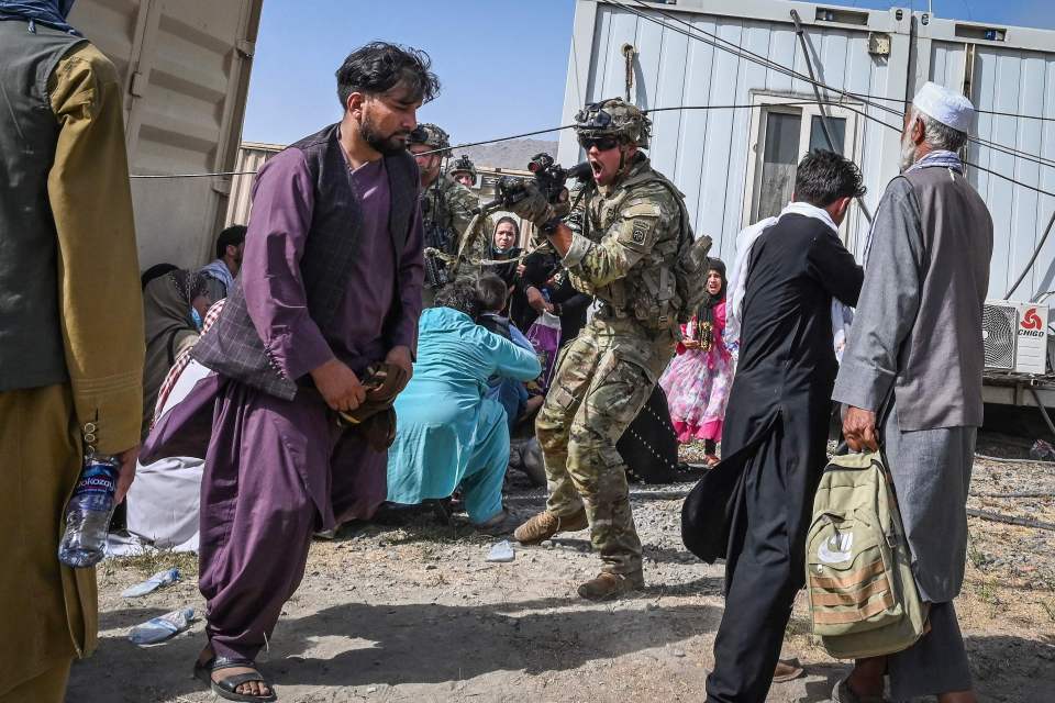 A US soldier points his gun as chaos unfolds in Kabul