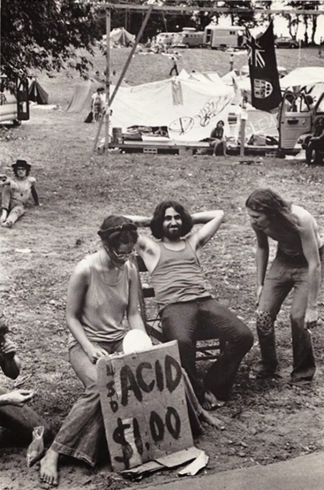 A man looks pleased with himself as he appears to be selling $1 acid