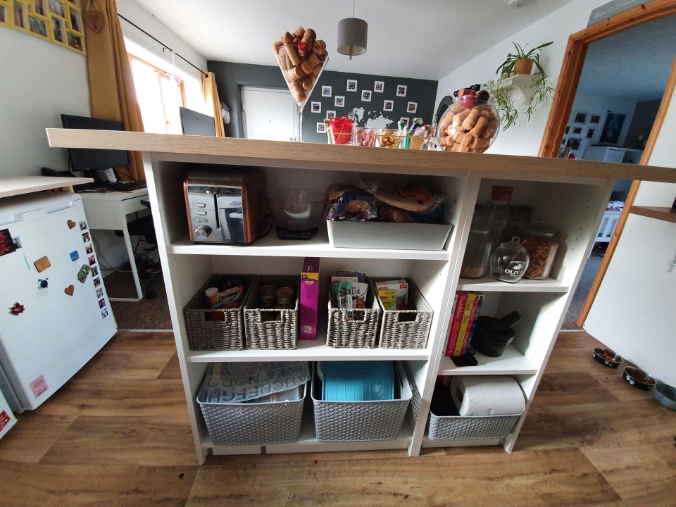 Vikki screwed the top of a desk over the bookcases