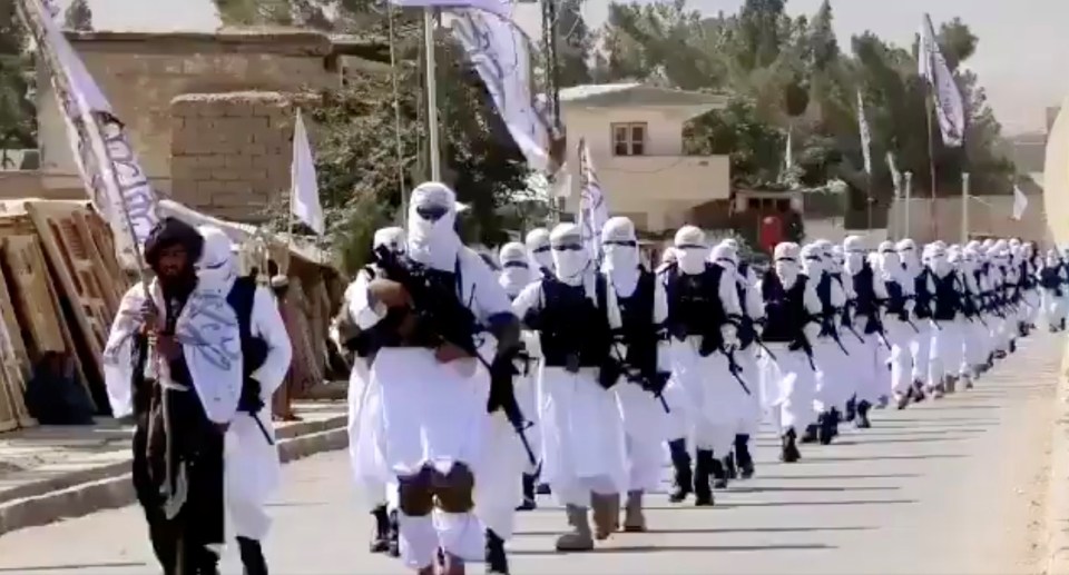 Taliban fighters march in uniforms on the street this week in Qalat, Zabul Province