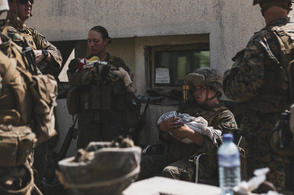 US forces cradle babies as they desperate escape from Afghanistan continues in Kabul