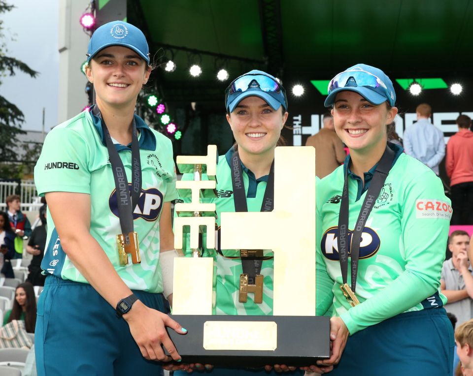 Grace Gibbs, Mady Villiers and Alice Capsey (left to right) celebrating with the Hundred trophy