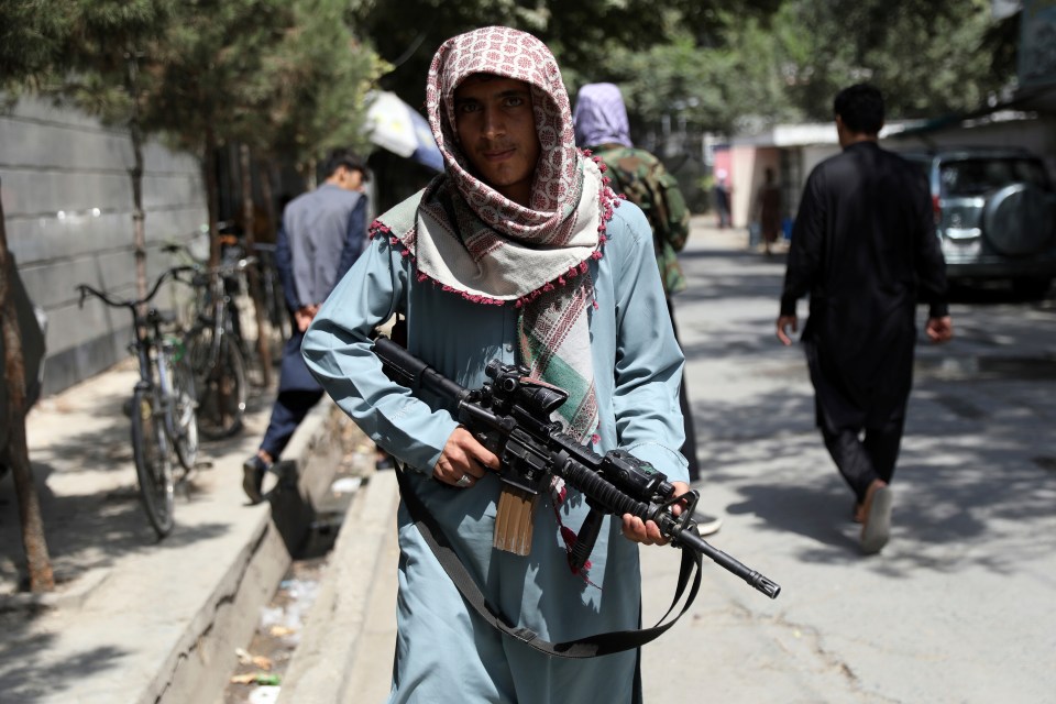 Taliban fighters patrol with US-made weapons