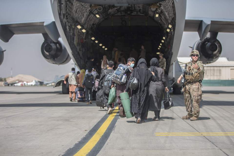 Families begin to board a US Air Force Boeing at Kabul Airport