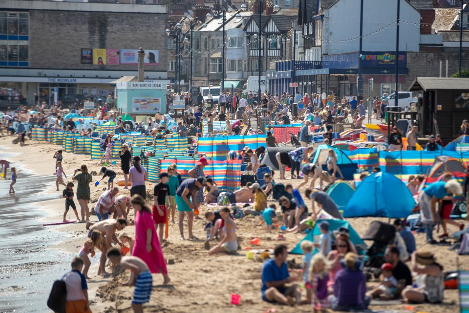 Families pack the sand to enjoy the summer sun in the final weeks of the school holidays